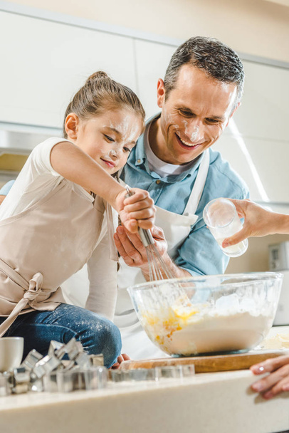 kid with father mixing dough - Photo, Image