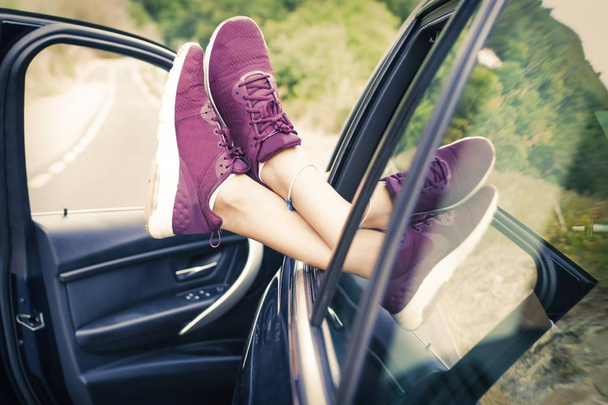 feet in the car window, concept of travel and vacation - Fotó, kép