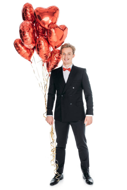 homem com balões em forma de coração
 - Foto, Imagem