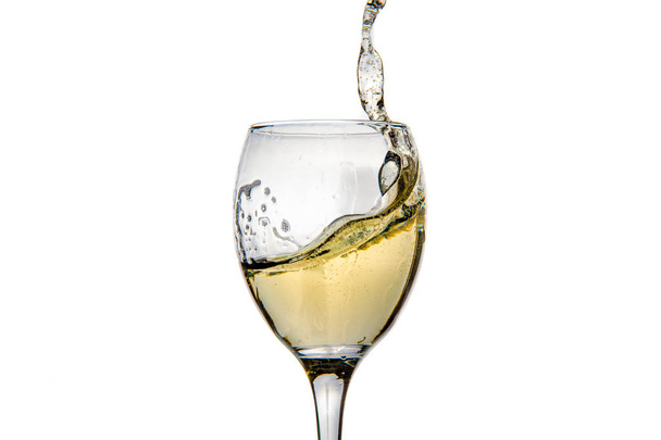 Wineglass with splashing drops of champagne - Fotó, kép