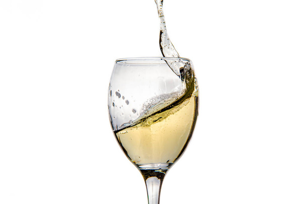 Wineglass with splashing drops of champagne - Foto, afbeelding