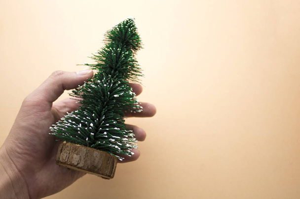 hand pick christmas tree on background - Foto, immagini