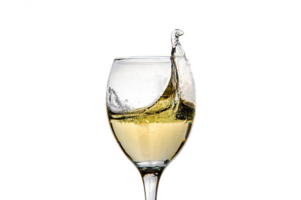 Wineglass with splashing drops of champagne - Foto, afbeelding