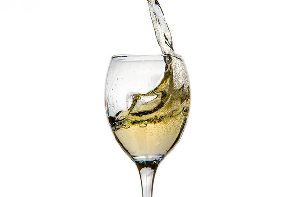 Wineglass with splashing drops of champagne - Photo, image