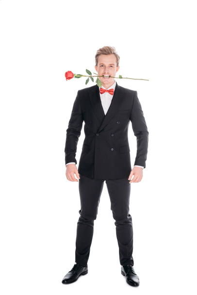 stylish man with rose in teeth - Foto, afbeelding