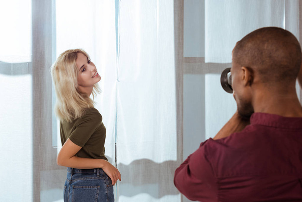 african american photographer taking photo of attractive model in studio - Photo, image