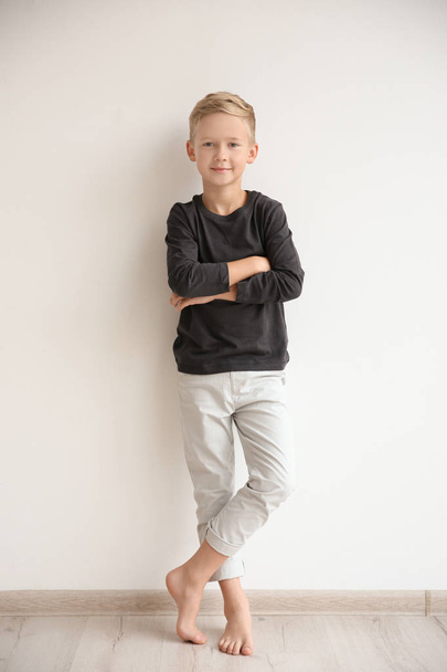 Cute little boy standing near wall at home - Fotografie, Obrázek