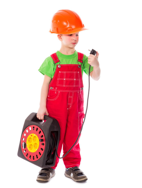 Little builder in helmet with electrical extension cord - Fotoğraf, Görsel