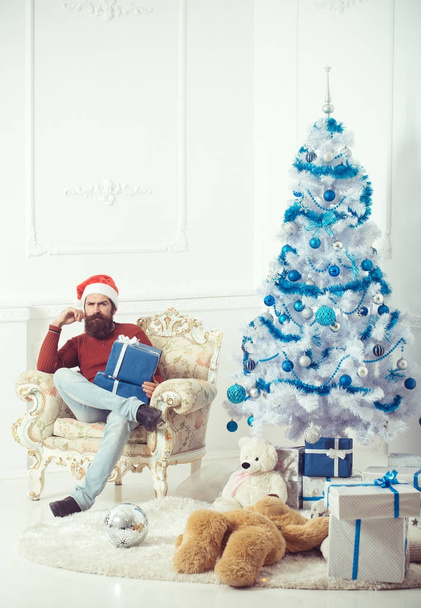 New year guy at blue Christmas tree. - Photo, Image