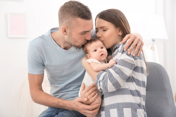 Happy young family with cute baby at home - Foto, Bild