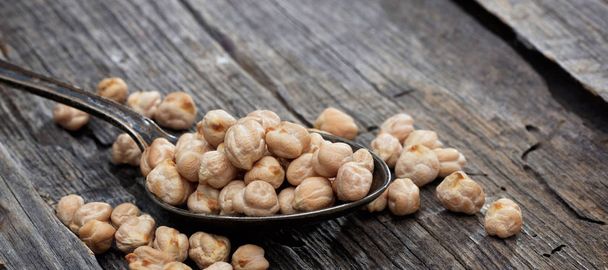 Chickpeas on an old wooden table - Photo, Image