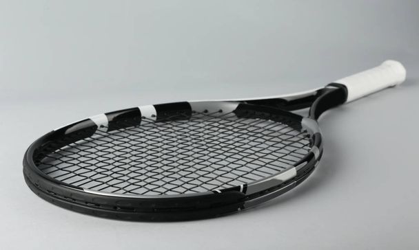 Tennis racket on grey background - Φωτογραφία, εικόνα