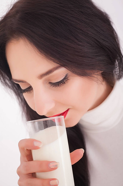 beautiful young woman holding a glass of milk - Photo, Image