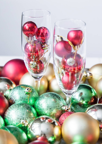 Christmas balls in wineglass on a bright abstract background - Foto, immagini