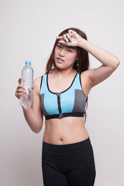 Beautiful Asian healthy girl with bottle of drinking water. - Zdjęcie, obraz