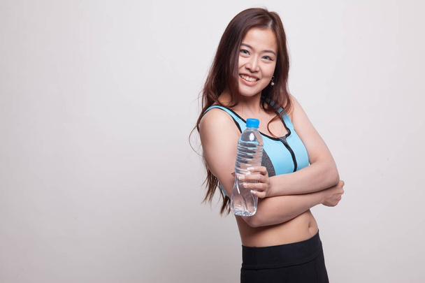 Beautiful Asian healthy girl with bottle of drinking water. - Photo, Image