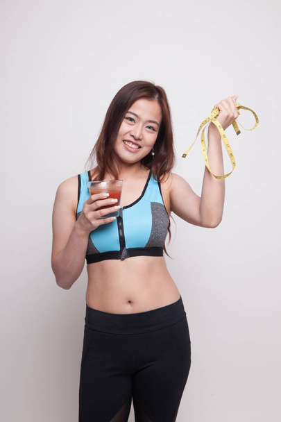 Healthy Asian girl diet with tomato juice and measuring tape on  - Fotografie, Obrázek