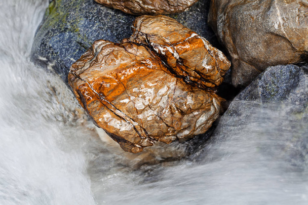 stone under the mountain water, note shallow depth of field - Photo, Image