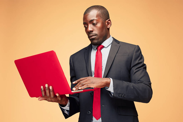 Handsome Afro American man sitting and using a laptop - Φωτογραφία, εικόνα