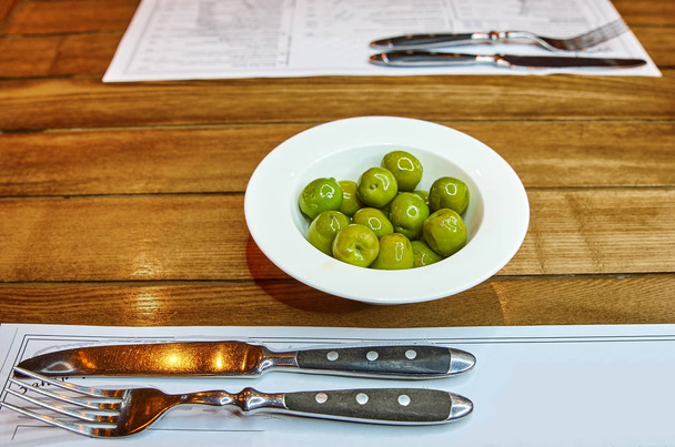 green olives on a table in a restaurant - Photo, image