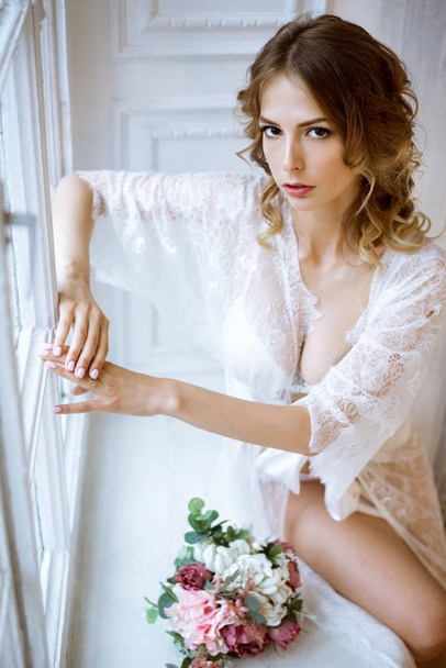 Beautiful sexy lady in elegant white robe - 写真・画像