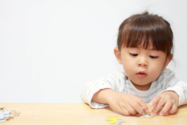Chica japonesa haciendo rompecabezas (3 años)
) - Foto, imagen