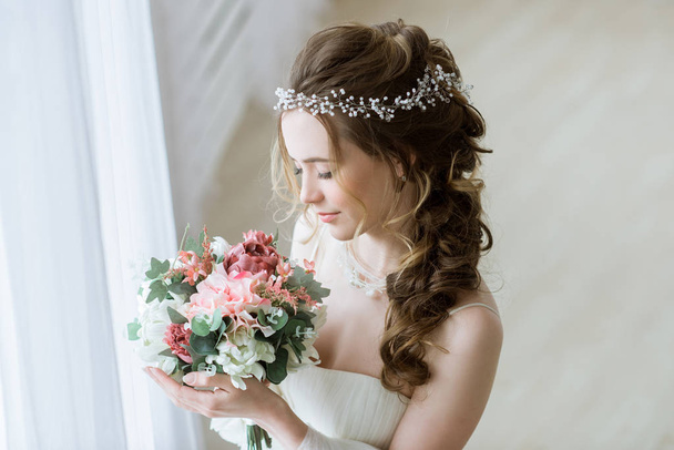 Brunette bride in fashion white wedding dress with makeup - 写真・画像