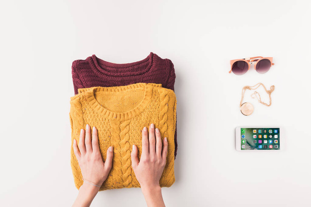 hands with sweaters and iphone - 写真・画像