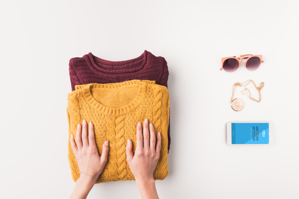 sweaters and smartphone with skype - 写真・画像