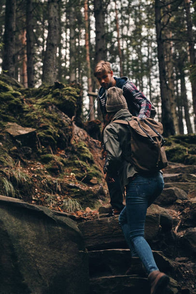 couple hiking together in mountain woods - Foto, afbeelding