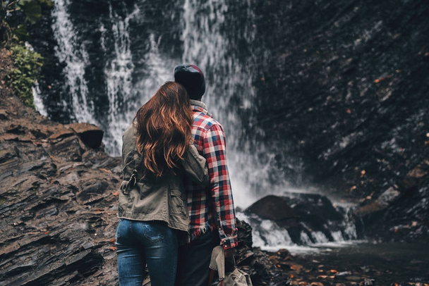 couple in love embracing near waterfall - Φωτογραφία, εικόνα
