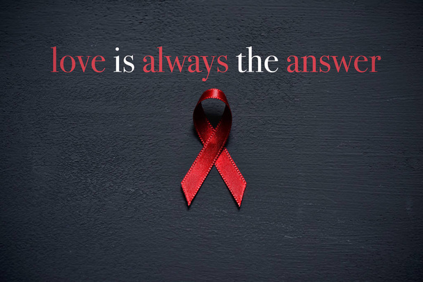 red ribbon and text love is always the answer - Photo, Image