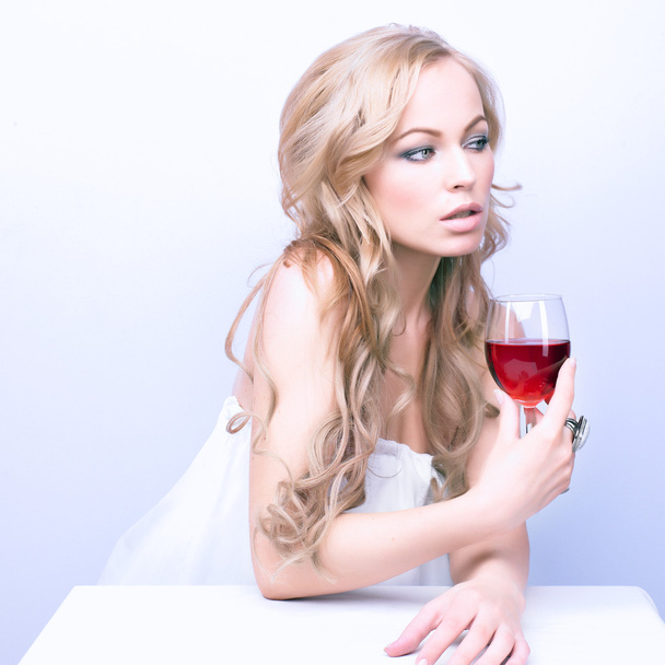 Beautiful blond woman with glass red wine - Photo, image