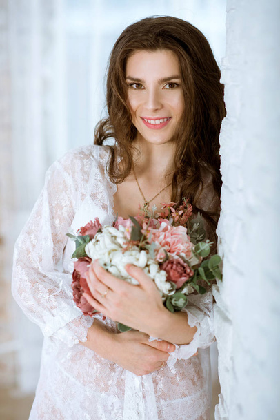 Fashionable female portrait of cute lady in white robe indoors - Zdjęcie, obraz