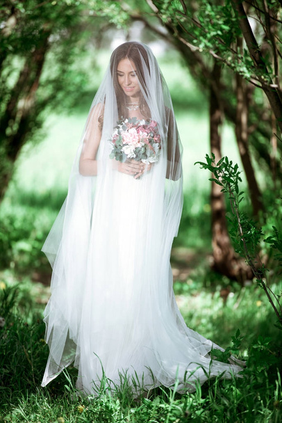 Brunette bride in fashion white wedding dress with makeup - Fotoğraf, Görsel