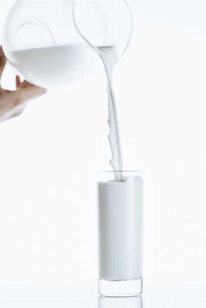 牛乳瓶から注ぐミルク - 写真・画像