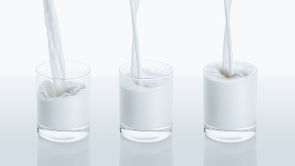 milk pouring into three glasses - 写真・画像