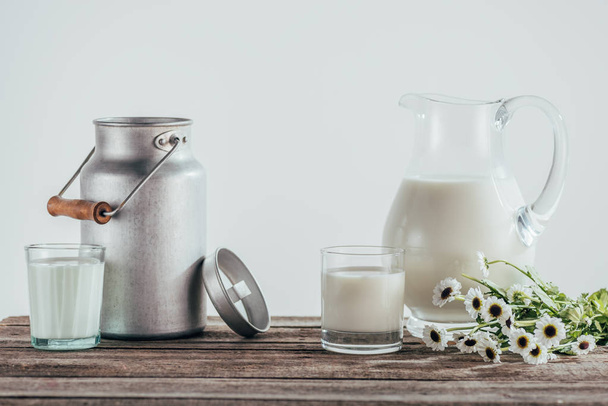 jugs and two glasses of fresh milk  - Фото, зображення