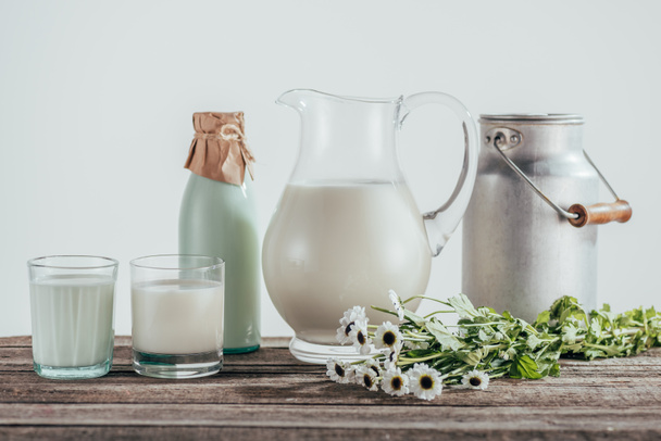 jugs, bottle and glasses of fresh milk - Фото, зображення