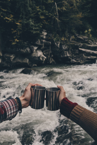 hands holding travel iron cups - Photo, Image