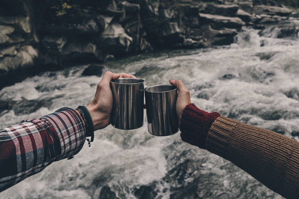 hands holding travel iron cups - Photo, Image