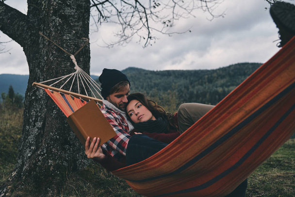 couple reading book in hammock - Photo, image