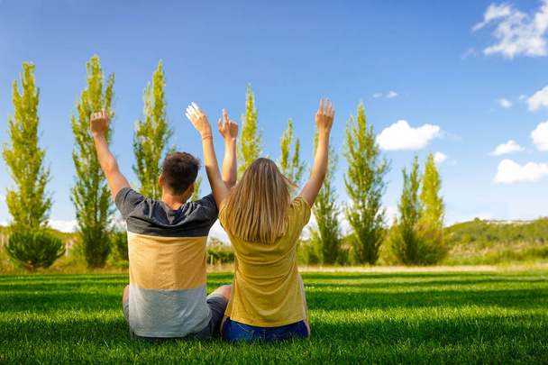couple sitting on green grass - Photo, Image