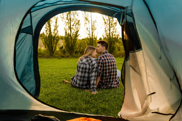 couple hugging sitting at camping  - Foto, afbeelding