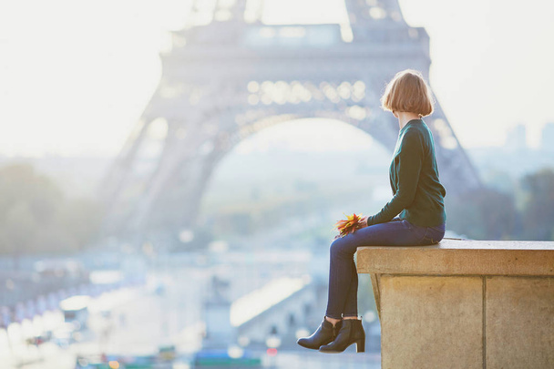 Girl in Paris near the Eiffel tower at morning - Фото, изображение