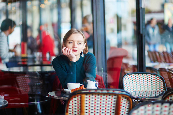 Young elegant woman drinking coffee in cafe in Paris, France - Photo, Image