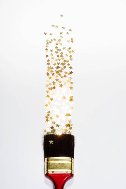 Shining stars confetti splashing from paintbrush - Fotoğraf, Görsel