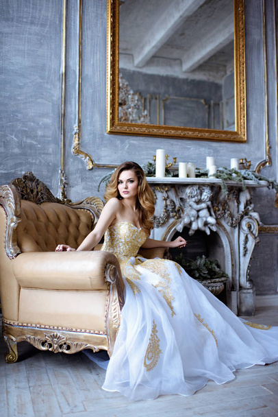 Beauty bride in bridal golden gown indoors - Photo, image