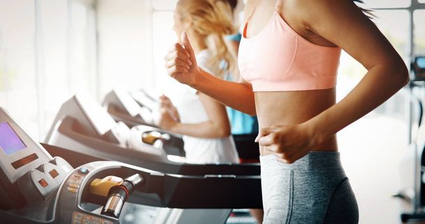 friends exercising on treadmill machine - Foto, Imagen