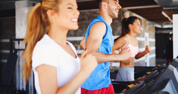 friends exercising on treadmill machine - Foto, imagen